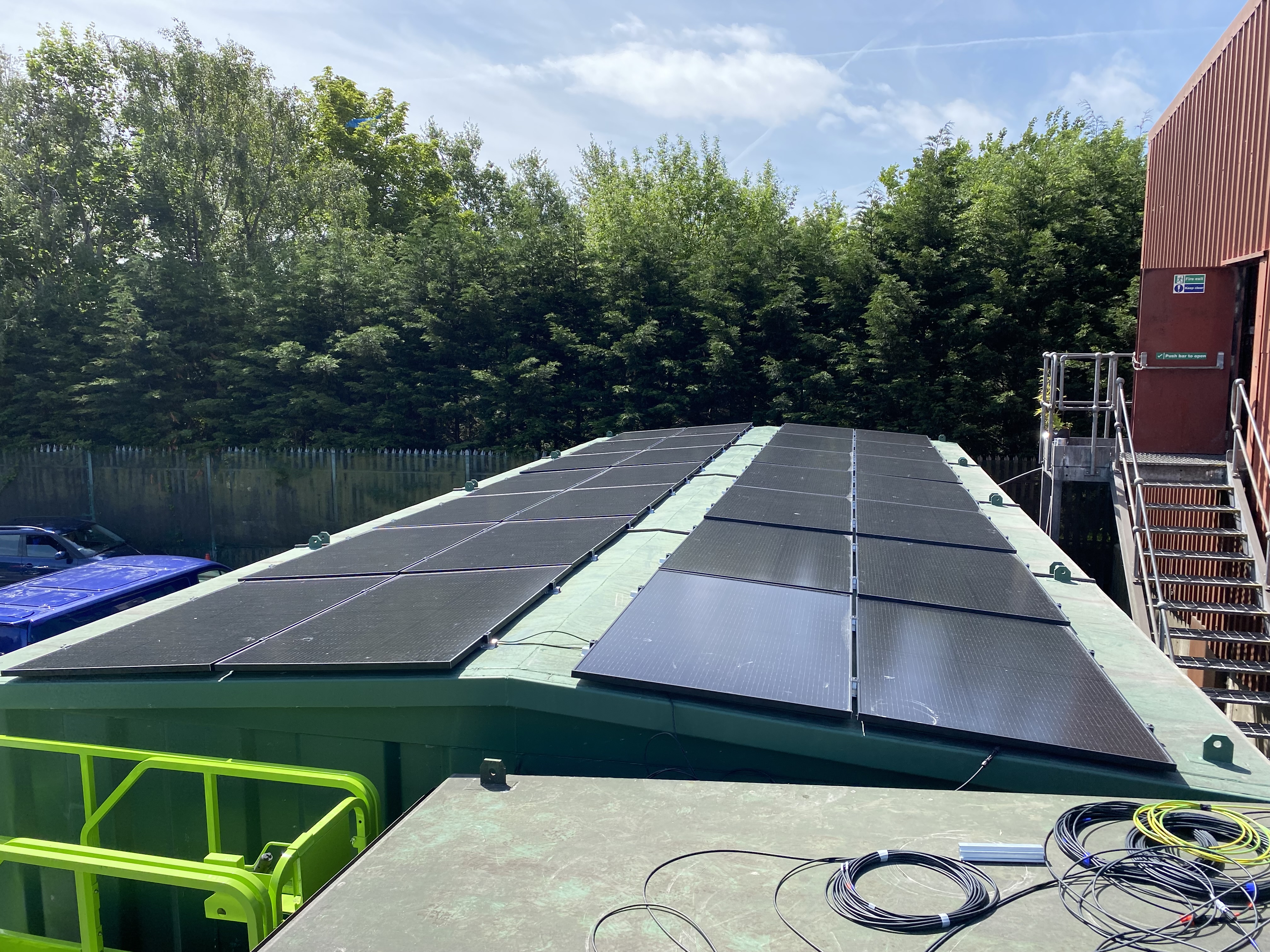 Swansea Recycling Plant solar panels on container rooftop with blue containers